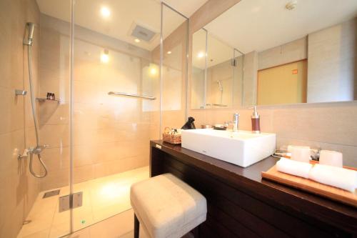 a bathroom with a sink and a shower at Tensui Saryo in Hakone