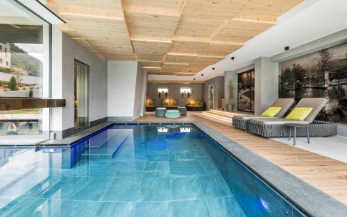 a pool in a house with a living room at Hotel Clara in Bressanone