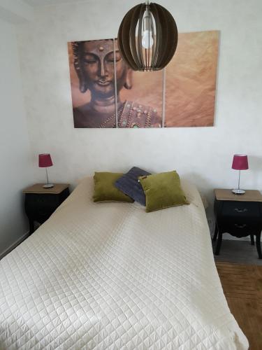 a bedroom with a large white bed with two lamps at J House in Jyväskylä