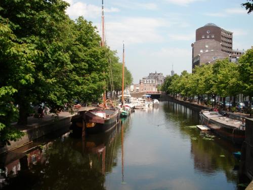 a river with boats docked in a city at MAFF Top Studio Apartment in The Hague