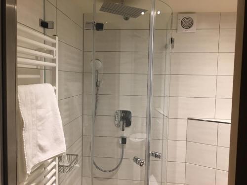 a bathroom with a shower with a glass door at Gasthof zum Ochsen in Mössingen