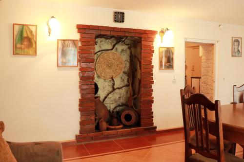 a brick fireplace in a living room at GreenGate in Gurjaani