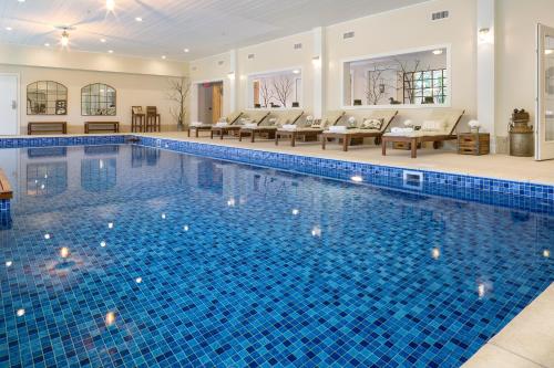a large swimming pool with blue tiles in a house at 506 On the River Inn Woodstock in Woodstock