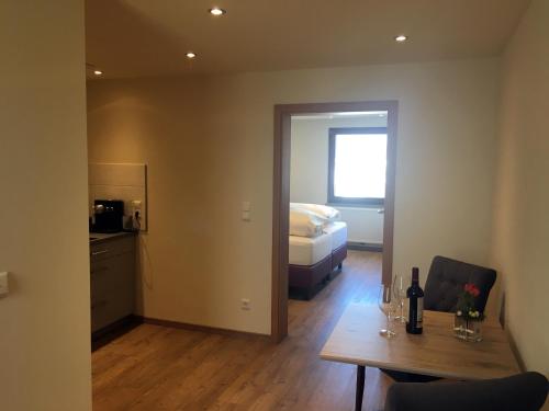 a room with a bed and a table with wine glasses at Gasthof zum Ochsen in Mössingen