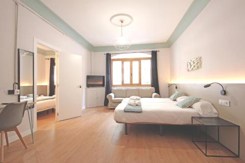 a room with a bed, a desk, and a window at Regina in Palma de Mallorca