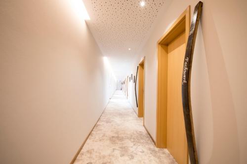 a corridor of hallway with white walls and a long aisle at Hotel Restaurant zur Marienburg in Pünderich