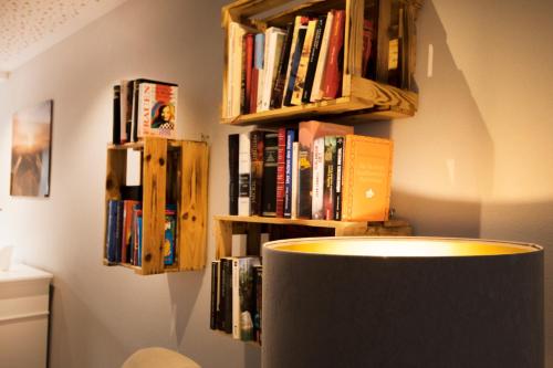 a room with books on a wall with a shelf of books at Hotel Restaurant zur Marienburg in Pünderich