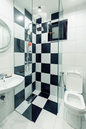 a bathroom with a black and white checkered floor at Town hostel in Peje