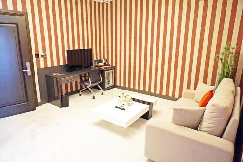 a living room with a white couch and a table at Svalinn Hotel in Izmir