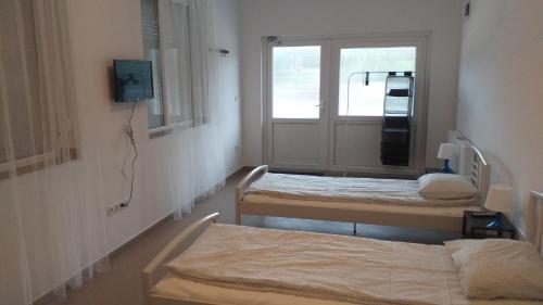 a room with two beds and a window at Kisdunapart 510 in Taksony