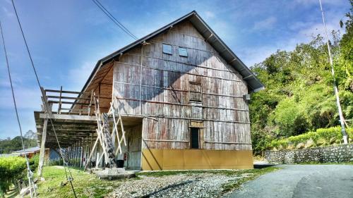 an old barn sitting on the side of a road at Borneo Tribal Village (BTV) in Pelaman Sodoh