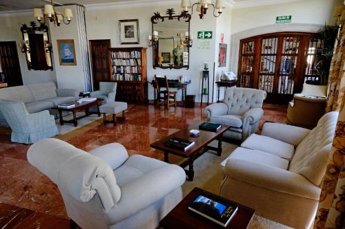 a living room with couches and chairs and a table at Parador de Ferrol in Ferrol