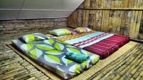 two beds sitting on top of a wooden floor at Borneo Tribal Village (BTV) in Pelaman Sodoh