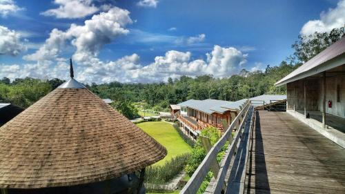 a view of a resort with a deck and a building at Borneo Tribal Village (BTV) in Pelaman Sodoh