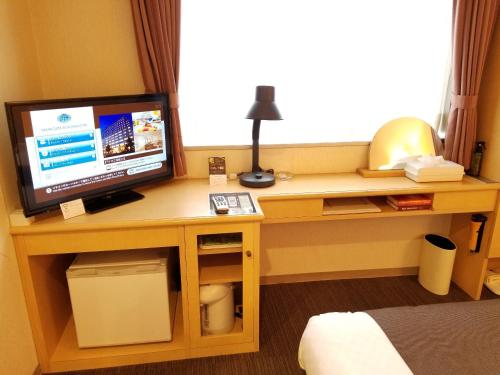 a room with a desk with a computer on it at Yamagata Kokusai Hotel in Yamagata