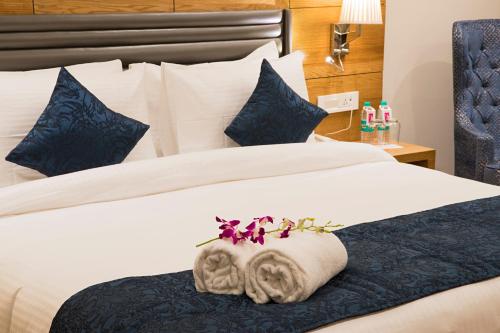 a hotel room with a bed with towels on it at Regenta Central Cassia Zirakpur Chandigarh in Chandīgarh