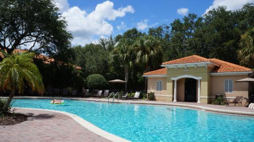 a swimming pool in front of a house at Beautiful Hollywood style home next to Disney in Kissimmee
