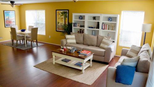 a living room with a couch and a table at Beautiful Hollywood style home next to Disney in Kissimmee