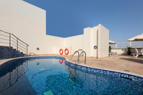 a swimming pool in the middle of a building at Landmark Premier Hotel in Dubai