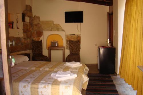 A bed or beds in a room at Pazinos Village Studios