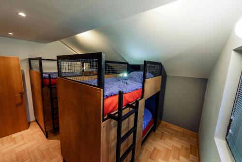 a room with two bunk beds in a attic at Town hostel in Peje