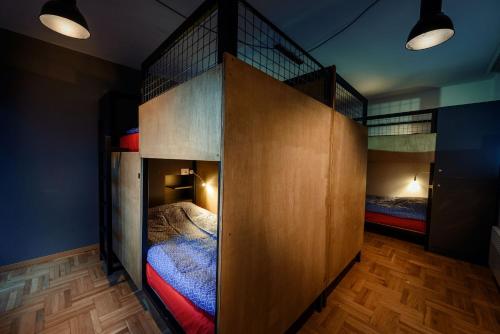 two bunk beds in a room with wooden floors at Town hostel in Peje