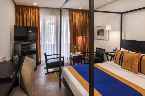 a hotel room with a bed and a living room at The Park Bangalore, MG Road in Bengaluru