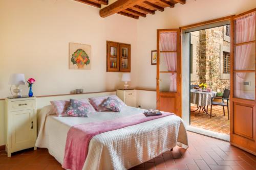 a bedroom with a bed and a window at Castello di Cafaggio Borgo in Impruneta