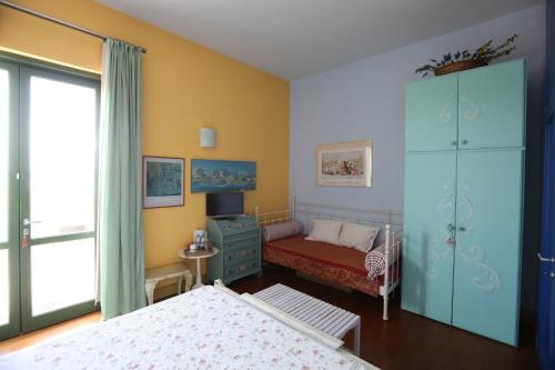 a bedroom with a bed and a dresser at IL NIDO AL LAGO in Gavirate