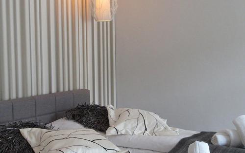 a person laying on a bed under a blanket at Boutique-Hotel „Altes Rathaus“ in Lahnstein