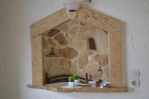 a mirror hanging on a wall in a room at Athena Rooms in Kato Zakros