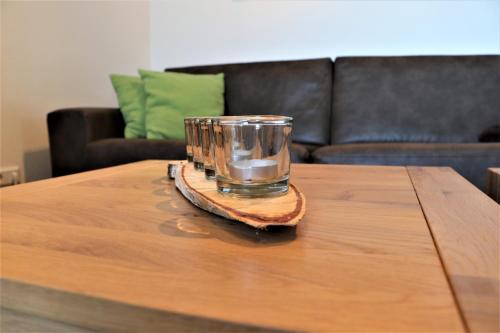 a glass sitting on top of a wooden table at UplandParcs Residence Astenberg in Winterberg