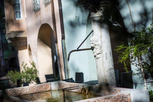a water fountain in front of a building at Albergo Diffuso ELA Living - Apartment Bellepoque in Egna