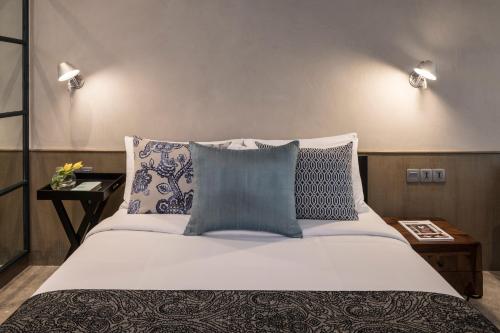 a bedroom with a large bed with blue and white pillows at The Park Bangalore in Bangalore