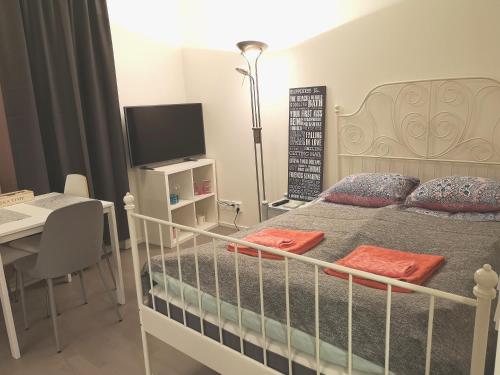 a bedroom with a bed and a desk with a computer at The Seabreeze Apartment Turku in Turku