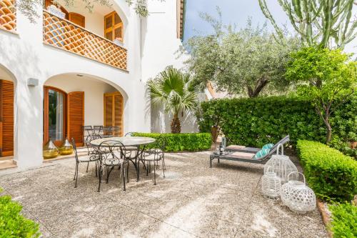 an outdoor patio with a table and chairs at La Matrangela Charme Apartments in Taormina