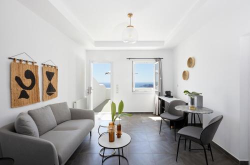 a living room with a couch and chairs and a table at Petit Palace Suites in Fira