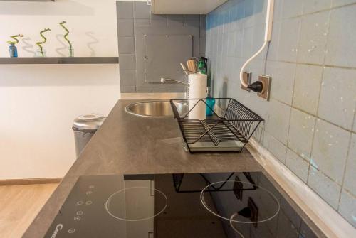 a kitchen with a sink and a counter top at Travel Homes - The Bluefel, 2m walk Little Venice in Colmar