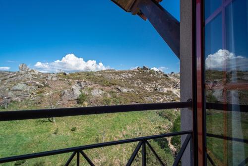 a view of a mountain from a window at Alojamento Local - Miradouro do Castelo in Castro Laboreiro