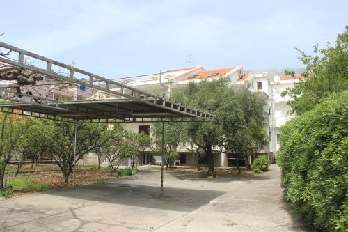 a bridge over a park with trees and buildings at Nir Apartments Budva in Budva