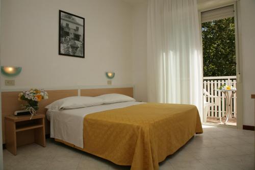 Un pat sau paturi într-o cameră la Hotel Giuliana