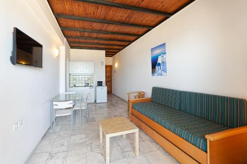 a living room with a couch and a table at Olympic Suites in Rethymno Town