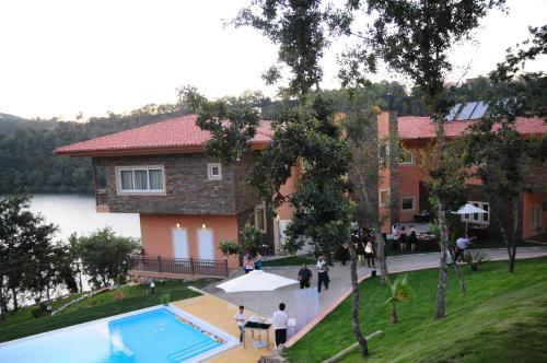a rendering of a house with a swimming pool at Hotel Rural Quinta da Conchada in Aguieira