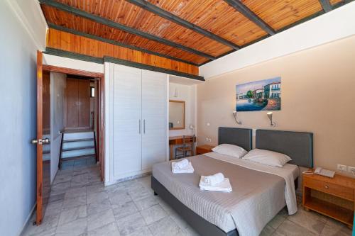 Posteľ alebo postele v izbe v ubytovaní Olympic Suites