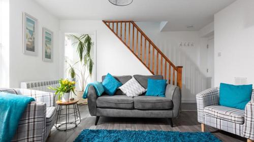 a living room with a couch and a chair at Corner Cottage Mevagissey in Mevagissey