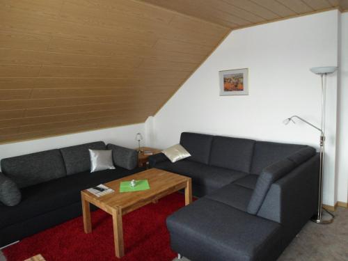 a living room with a couch and a table at Haus Fernblick in Bad Grund