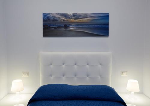 a bedroom with a blue bed and two lamps at Residenza Duomo in Avezzano