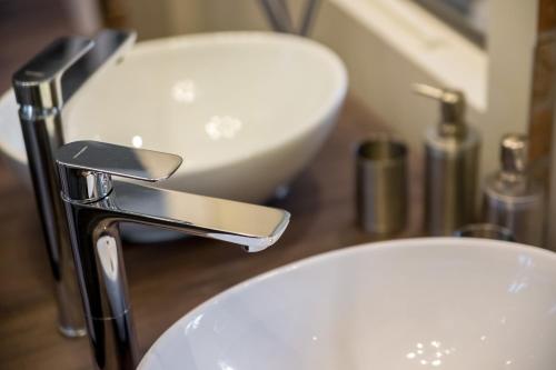 a bathroom with a sink and a faucet at Deluxe Ploech in Rijeka