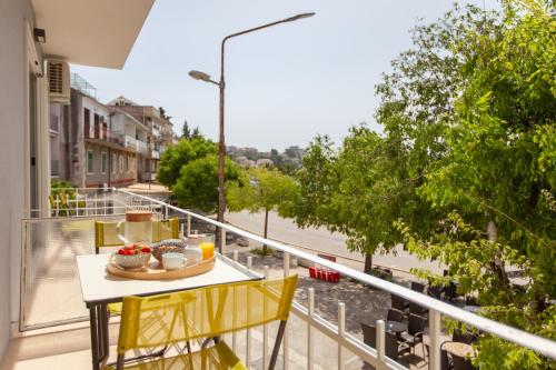a balcony with a table with food on it at Apartments Coast 27 in Podgora