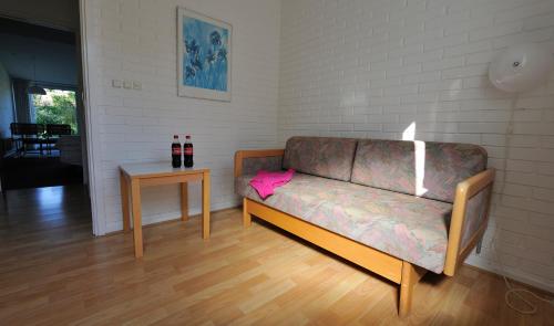 a couch with a pink object on it in a room at Hotel Balka Strand in Neksø